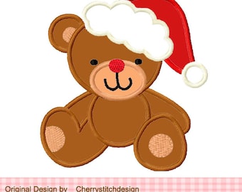 May include: A brown teddy bear wearing a red and white Santa hat. The bear is sitting with its legs crossed and has a happy expression on its face.