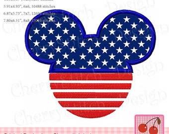 May include: An embroidery design featuring a Mickey Mouse ear shape in the colours of the American flag. The ears are blue with white stars and the bottom is red and white stripes.