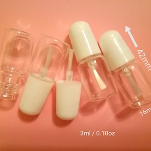 May include: Five clear glass bottles with white caps and a brush applicator. The bottles are 42 mm tall and 16 mm wide. The bottles are labelled 3 ml / 0.10 oz.