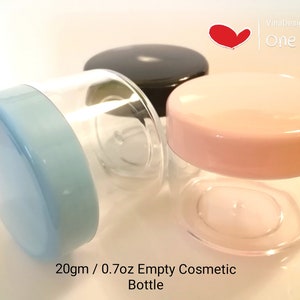 May include: Three empty cosmetic jars with lids. The jars are clear plastic and the lids are blue, pink, and black. The jars are 20 grams or 0.7 ounces in size. The text on the image reads "20gm / 0.7oz Empty Cosmetic Bottle".