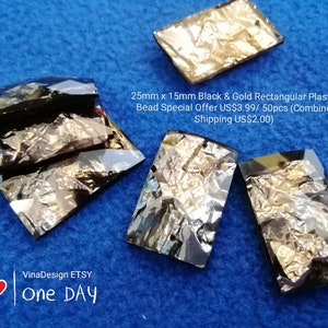 May include: A close-up of black and gold rectangular plastic beads. The beads are 25mm x 15mm and have a textured, iridescent finish.