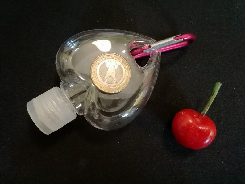 50ml/1.7oz Empty Flip Cap Plastic Heart Shape Bottle w/Buckle Clear hand Sanitizer Bottle Hand Cleanser Empty Flip Hanging Bottle Gel Bottle Size comparison with a Cherry and a coin