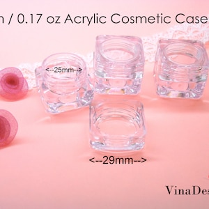 May include: Four clear acrylic cosmetic jars with lids. The jars are square shaped and measure 25mm wide and 29mm long. The jars are 23mm tall.