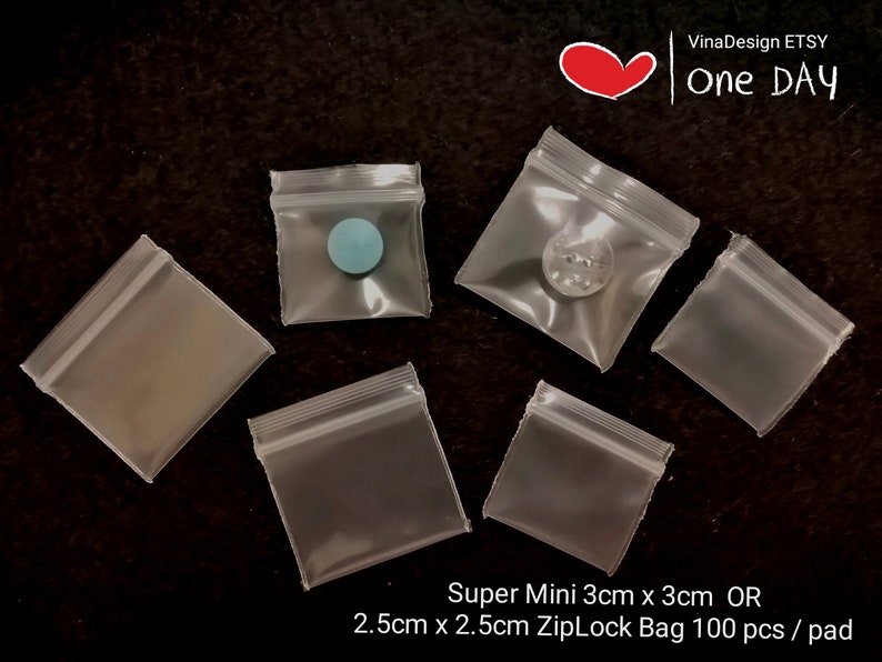 May include: A pack of 100 clear plastic resealable bags, also known as Ziploc bags, in two sizes: 3 cm x 3 cm and 2.5 cm x 2.5 cm. The bags are shown with small objects inside to demonstrate their size.