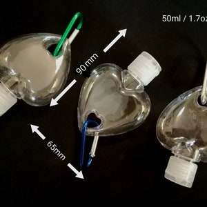 May include: Three clear plastic heart-shaped bottles with a carabiner clip. Each bottle holds 50 ml / 1.7 oz of liquid. The bottles are 90 mm tall and 65 mm wide.