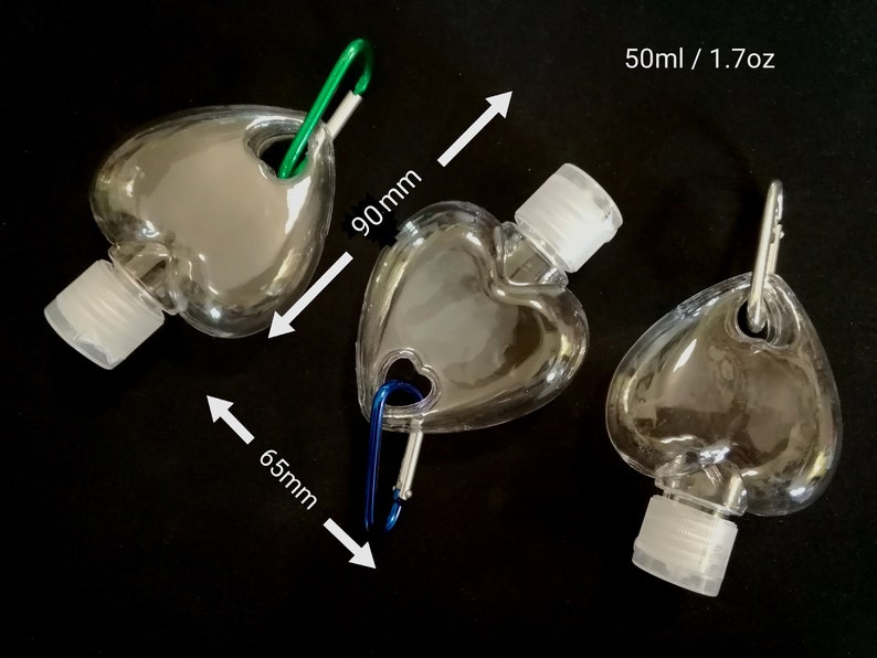 May include: Three clear plastic heart-shaped bottles with a carabiner clip. Each bottle holds 50 ml / 1.7 oz of liquid. The bottles are 90 mm tall and 65 mm wide.
