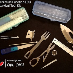 May include: A set of 10 mini survival tools in a clear plastic case. The tools include a knife, a fork, a pair of scissors, a ruler, a tweezers, a needle, a magnifying glass, a bottle opener, a key ring, and a small metal object. The tools are all silver in color and are arranged on a black background.