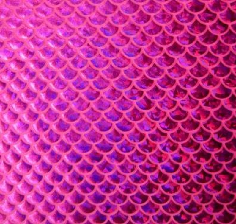 May include: A close-up of a pink and purple mermaid scale pattern. The scales are arranged in neat rows, creating a textured surface. The color transitions from a bright pink to a deeper purple, giving the pattern depth and dimension.