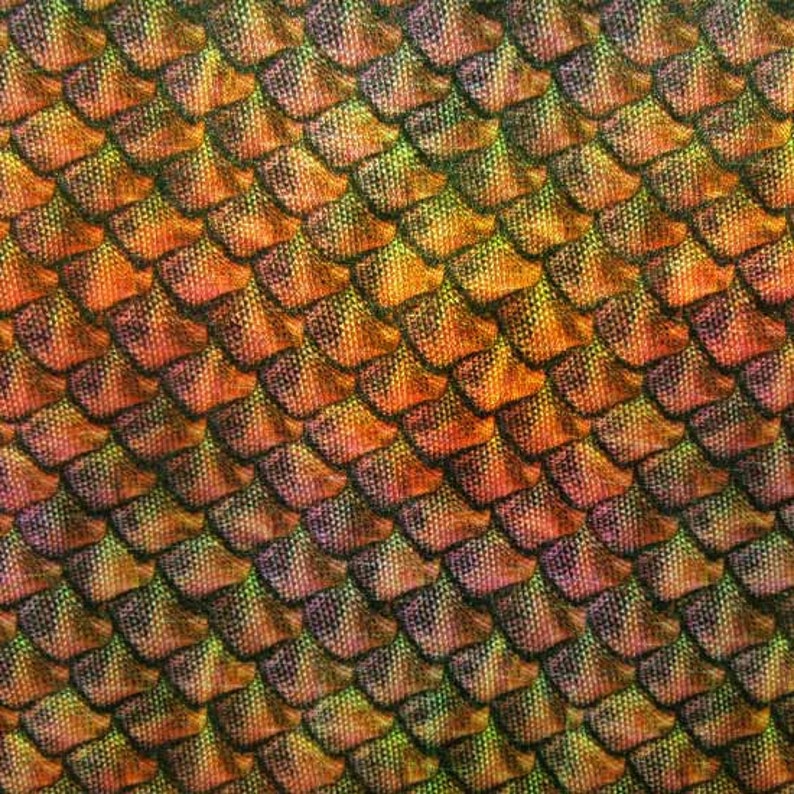 May include: Close-up of a fabric with a repeating pattern of overlapping, scale-like shapes. The scales transition in color from orange to yellow and purple, with dark outlines, creating a textured, iridescent effect. The overall theme is fantasy or reptile.