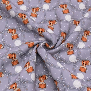 May include: A purple fabric with a repeating pattern of orange foxes sleeping on white moons. The foxes are surrounded by thin, orange, circular lines.
