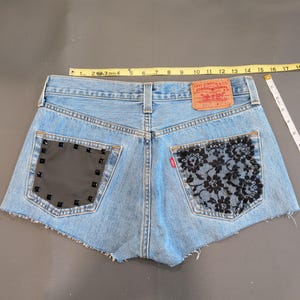 Vintage Levi's 501 size 31 waist button fly Denim Shorts Patched