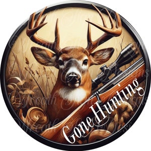 May include: A round, black-framed sign with a brown and white deer head and a rifle with a scope. The deer is looking directly at the viewer. The text "Gone Hunting" is written in white letters on the rifle.