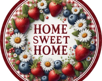 May include: A round sign with the words "HOME SWEET HOME" in red, surrounded by a wreath of strawberries, blueberries, and daisies. The background has a red and white checkered pattern, with a dark red border.