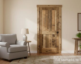May include: A rustic wooden door with full sawmarks and no finish. The door is made of vertical planks of varying widths and tones. The door is set in a neutral-toned room with a gray armchair, a side table with a lamp, and a small wooden table with plants.