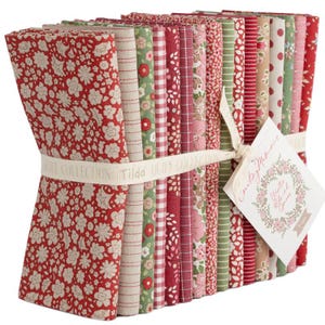May include: A stack of folded fabric squares in various patterns including floral, gingham, and stripes in shades of red, green, pink, and beige. The fabric bundle is tied with a cream ribbon featuring the text Tilda Quilt Collection.