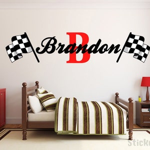 May include: A white wall with a black and white checkered flag on each side of the name "Brandon" with the letter "B" in red.