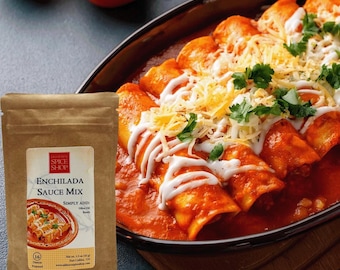 May include: A brown paper pouch of Old Town Spice Shop Enchilada Sauce Mix, net weight 1.5 ounces, featuring a label with a picture of enchiladas topped with cheese, cream, and cilantro, next to a dish of prepared enchiladas.