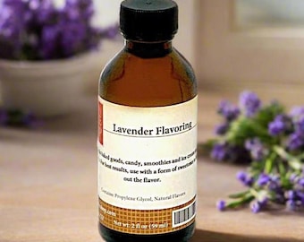 May include: A small amber glass bottle with a black screw-top lid containing lavender flavouring. The white label features the text Lavender Flavouring, usage instructions, and the net weight of 2 fl oz (59 ml) with a small barcode at the bottom.