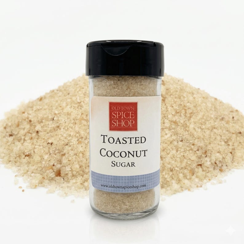 May include: A clear glass jar with a black lid, filled with toasted coconut sugar. The label reads "Old Town Spice Shop" and "Toasted Coconut Sugar." A pile of toasted coconut sugar is in the background. The website www.oldtownspiceshop.com is printed on the label.