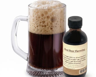May include: A glass mug of dark brown root beer with a frothy top, next to a small brown bottle. The bottle is labelled "Root Beer Flavoring" and includes instructions and ingredients for making root beer.