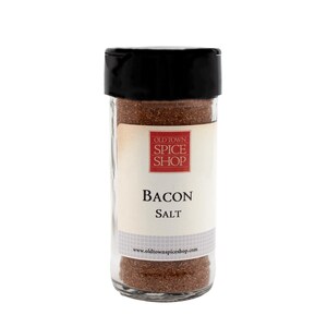 Puede incluir: Un frasco de vidrio con tapa negra lleno de sal de tocino marr&oacute;n. La etiqueta dice "Old Town Spice Shop" en rojo y "Bacon Salt" en negro.