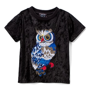 May include: Black velvet short-sleeved t-shirt with a sequined owl applique. The owl is blue, gray, and silver with red accents.