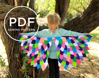 May include: A vibrant pair of wings with a feather design, crafted from felt in shades of pink, blue, green, and purple. The wings are being worn. The image also includes the text "PDF SEWING PATTERN".