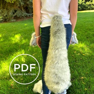 May include: PDF sewing pattern for a wolf tail costume. The tail is made of grey and white faux fur and is attached to a belt. The pattern includes instructions for making the tail and paws.