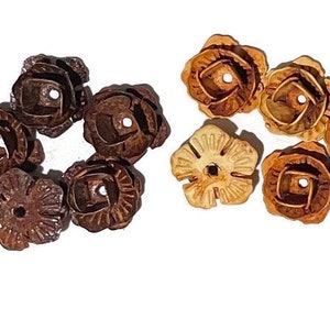 May include: A set of wooden flower-shaped beads, some are brown and some are light brown.