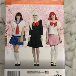 May include: Simplicity sewing pattern number 8160, size US 4, 6, 8, 10, 12, taille FR 32-40, for a sailor school girl costume. The pattern includes three different skirt styles: a blue pleated skirt, a black pleated skirt, and a pink pleated skirt. The pattern also includes a white blouse with a red bow tie and a sailor collar.