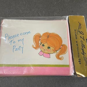 May include: A pink and white invitation card with a cartoon girl with red hair and blue eyes. The text on the card reads "Please come to my party".