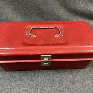 Fantastic red vintage utility box. Rusty beat-up industrial metal vintage container tackle art tool box.