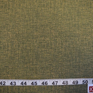 May include: A close-up of a green and gold fabric with a textured woven pattern. A ruler is visible at the bottom of the image with markings from 40 to 53 inches.