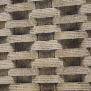 May include: Close-up of a woven fabric with a repeating pattern. The design features a series of rectangular shapes in varying shades of beige and brown, creating a textured, three-dimensional effect. The fabric appears to be made of a natural fiber.