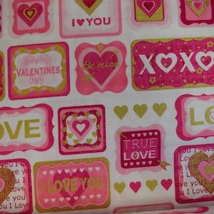 May include: Pink and gold fabric with a repeating pattern of hearts, XOXO, and the words "Love", "I Love You", "True Love", "Happy Valentines Day", and "Be Mine".