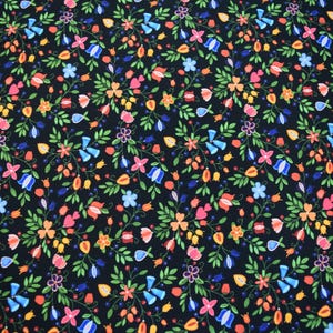 May include: A black fabric featuring a dense, repeating pattern of small, colorful flowers and green leaves. The floral design includes various shapes and sizes of blossoms in shades of pink, orange, yellow, and blue, arranged in a symmetrical layout.