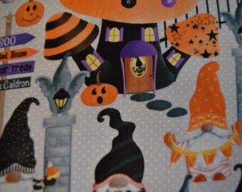 May include: A Halloween-themed fabric with gnomes, mushrooms, and a haunted house. The fabric features a gray background with white polka dots. The gnomes are wearing orange and black hats and holding signs that say "Boo", "Haunted House", "Trick or Treat", and "Witch's Cauldron".