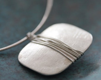 Necklace with handmade silver pendant with etched surface and wrapped wire (N0075)