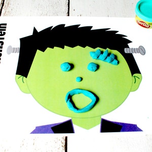 May include: A printable Frankenstein face template with the word "Frankenstein" printed on the left side. The face is outlined in black and has a green face with a blue Play-Doh mouth, eyes, and hair. There are two silver screws on the side of the head.