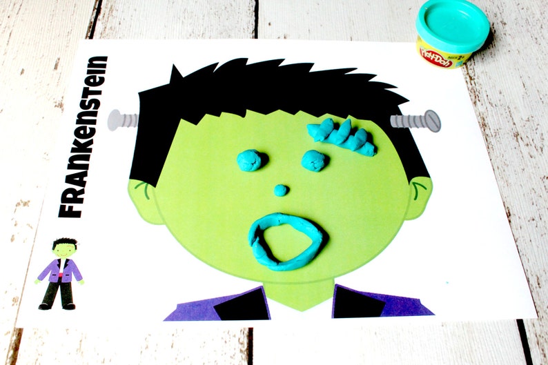 May include: A printable Frankenstein face template with the word "Frankenstein" printed on the left side. The face is outlined in black and has a green face with a blue Play-Doh mouth, eyes, and hair. There are two silver screws on the side of the head.
