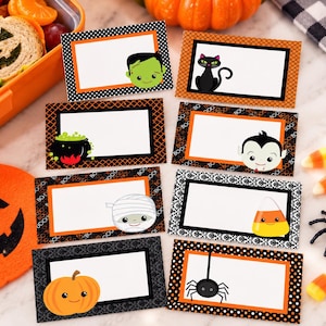 May include: A set of eight rectangular Halloween-themed labels with white center spaces for writing. Each label features a unique character or icon, including a green monster, black cat, cauldron, vampire, mummy, candy corn, pumpkin, and spider.