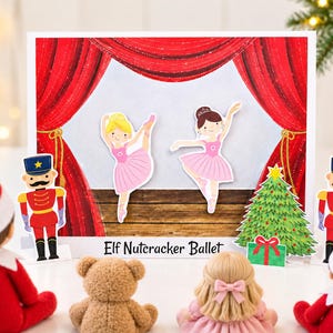 May include: A rectangular card featuring a stage with red curtains, two ballerinas in pink tutus, a Christmas tree, and two nutcracker figures. The text Elf Nutcracker Ballet is printed at the bottom centre of the card illustration.