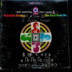 May include: A black and white vinyl record cover with a colourful circular design in the centre. The cover features the text "The Beat Goes On" in English, "Vanilla Fudge" in English, and text in other languages. The record is by the band Vanilla Fudge.