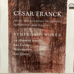 May include: A vintage record album cover featuring a brown and white abstract design. The album is titled "CÉSAR FRANCK" and features the Czech Philharmonic Orchestra conducted by Jean Fournet. The album includes the following symphonic works: Le chasseur maudit, Les Éolides, Rédemption, and Les Djinns.