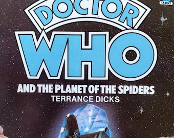 May include: A book cover featuring a blue and white "Doctor Who" logo and the title "And The Planet Of The Spiders" by Terrance Dicks. The background is a dark blue with stars.