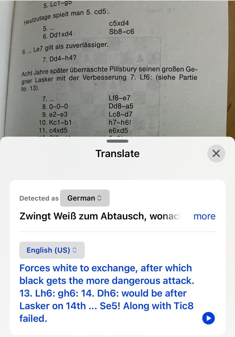 May include: A screenshot of a phone screen showing a chess game with the text "Zwingt Wei&szlig; zum Abtausch, wonach" in German, which translates to "Forces white to exchange, after which" in English. The text "Forces white to exchange, after which black gets the more dangerous attack. 13. Lh6: gh6: 14. Dh6: would be after Lasker on 14th ... Se5! Along with Tic8 failed." is also visible on the screen.