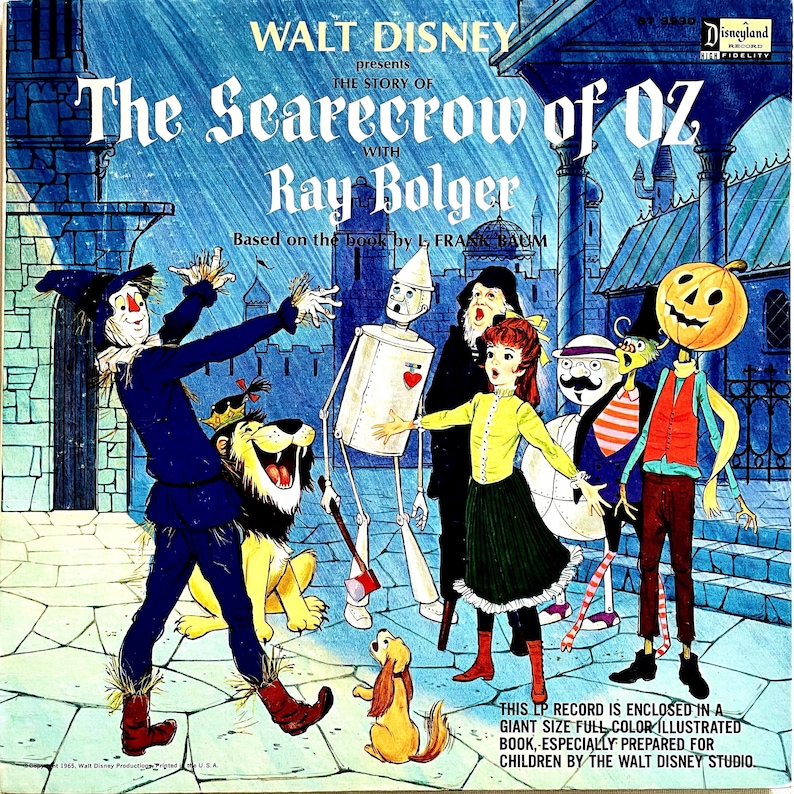 May include: Vintage Walt Disney LP record cover featuring characters from The Wizard of Oz. The cover art shows the Scarecrow, Tin Man, Lion, Dorothy, and other characters in a colorful illustration. The title reads "The Scarecrow of Oz" with Ray Bolger.