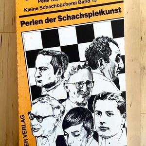 May include: A yellow book with black text titled "Perlen der Schachspielkunst" by Vladimir Budde, Erich Carl, and Peter Kleine. The book is part of a series called "Kleine Schachb&uuml;cherei Band 13". The cover features a black and white chessboard with illustrations of six people.