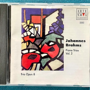 May include: CD case with a colorful abstract painting on the front. The text reads "Johannes Brahms Piano Trios Vol. 2 Trio Opus 8" and "Arte Nova Classics DDD".