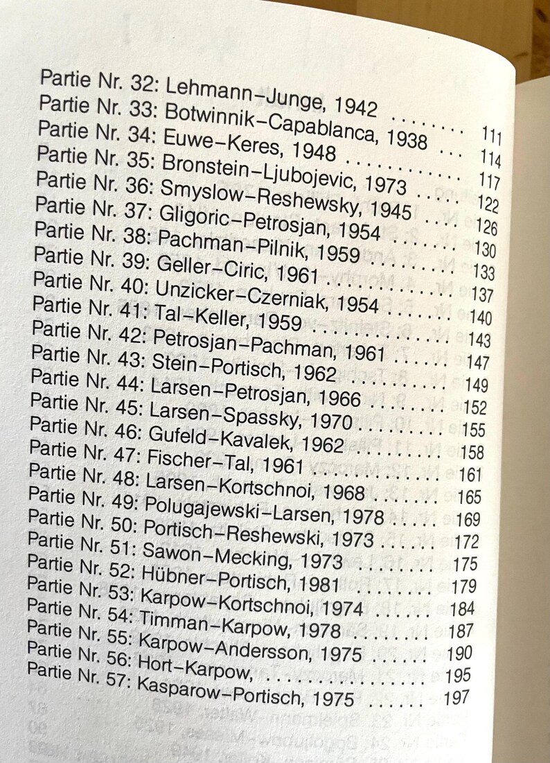 May include: A black and white list of chess games with the names of the players and the year they were played. The list includes games from 1938 to 1978.